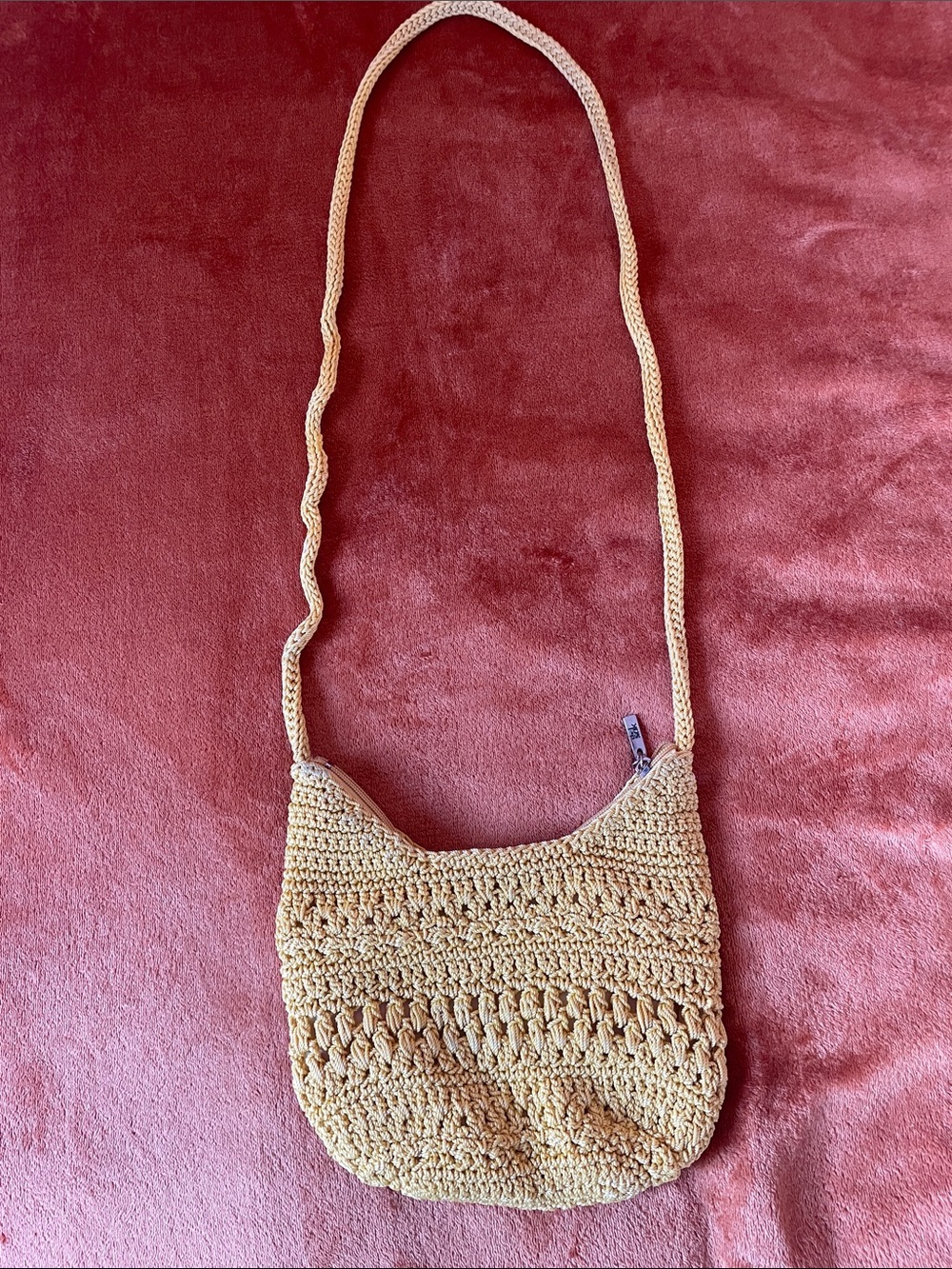 The Sak Handwoven Straw Crossbody in the color yellow